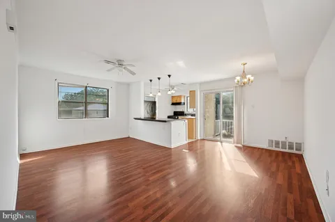 a view of a kitchen with wooden floor and a kitchen