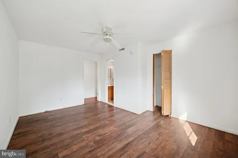 a view of an empty room with wooden floor