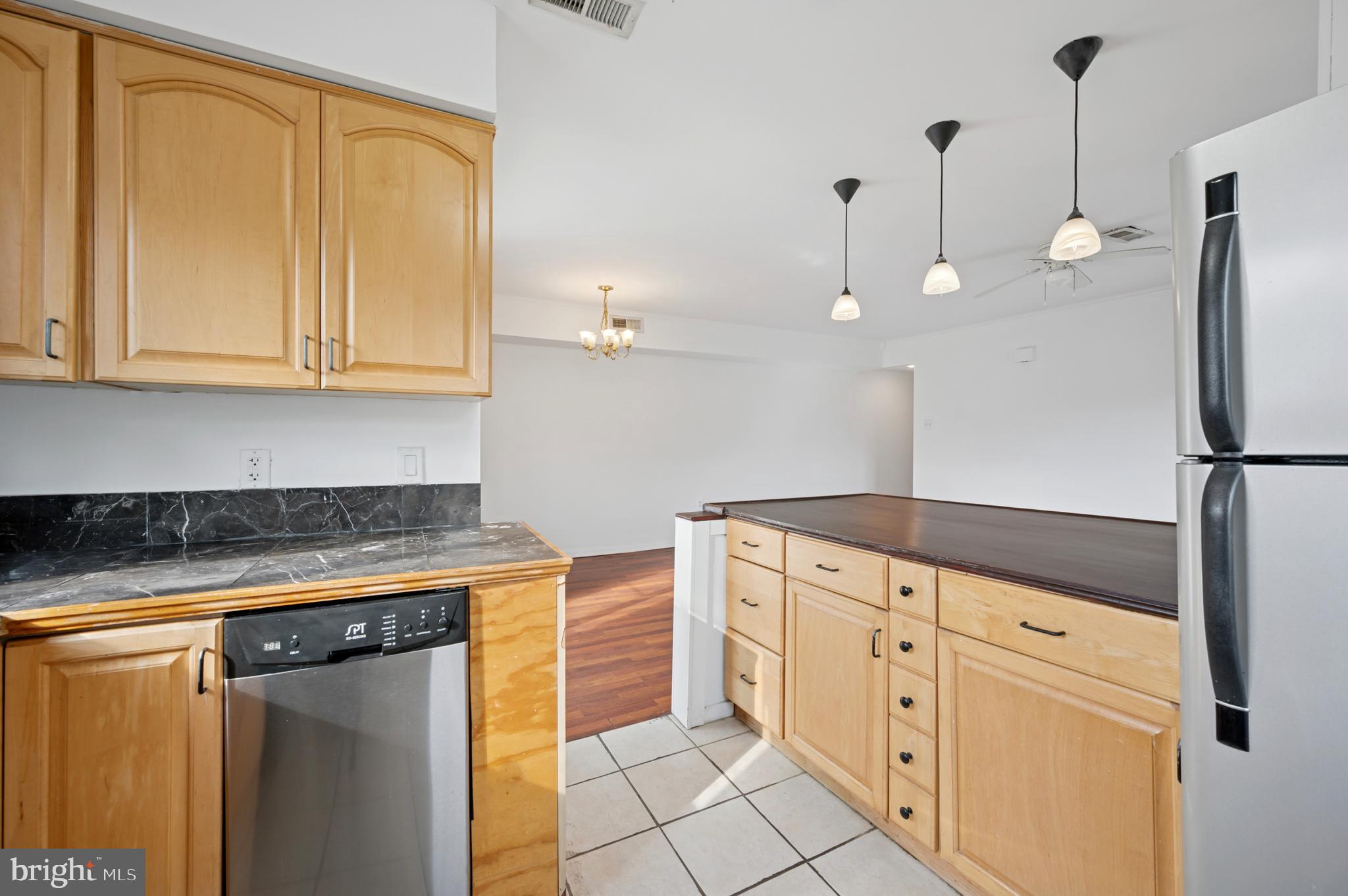 710 Willow Street, Unit B Lansdale, PA 19446 - Photo 10 of 25 a kitchen with stainless steel appliances granite countertop a refrigerator a sink and white cabinets