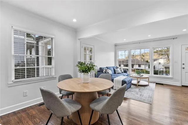 a view of a dining room with furniture window and wooden floor