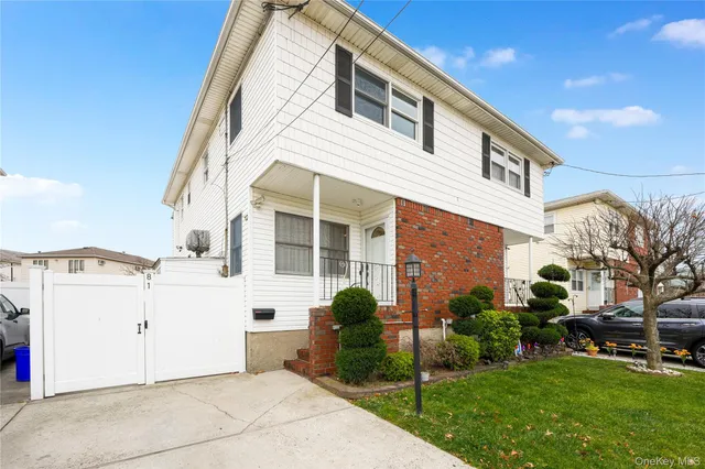 a view of a white house with a yard