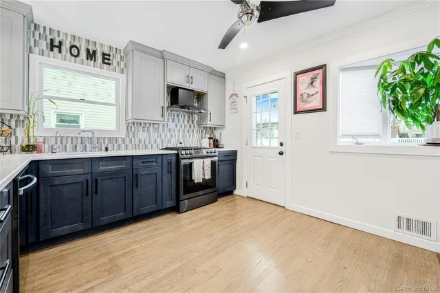 a kitchen with a sink cabinets and window