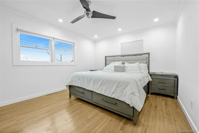 a bedroom with a bed and a night stand