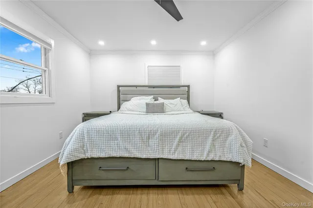 a bedroom with a bed and a painting on the wall