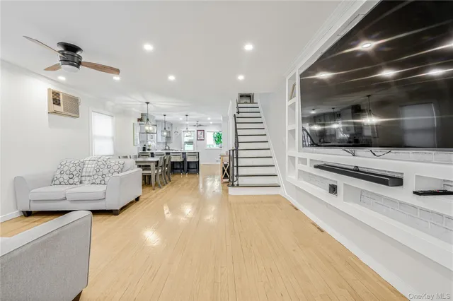 a large white room with kitchen view and living room view