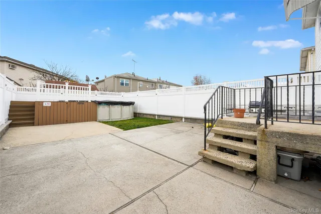 a view of a house with a wooden fence