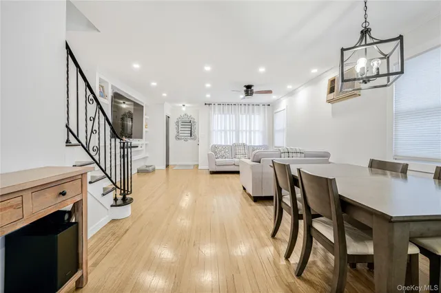a living room with furniture a fireplace and a chandelier