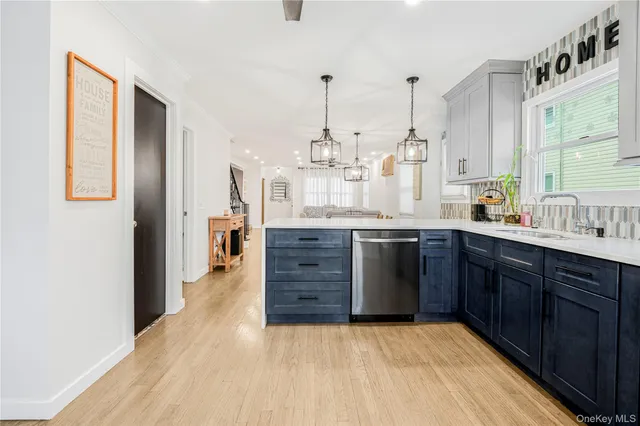 a kitchen with stainless steel appliances granite countertop a sink and a refrigerator