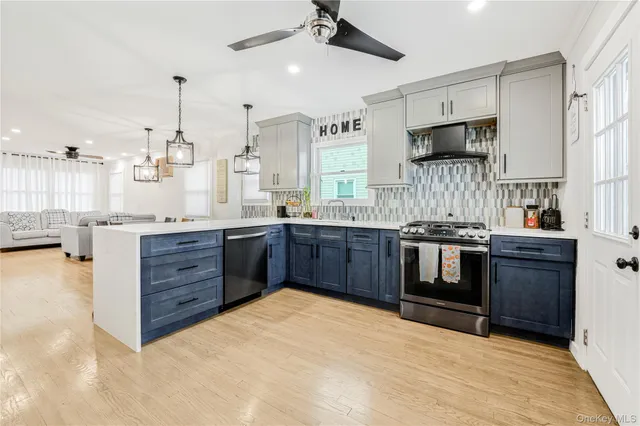 a kitchen with stainless steel appliances kitchen island granite countertop a stove a sink and a microwave
