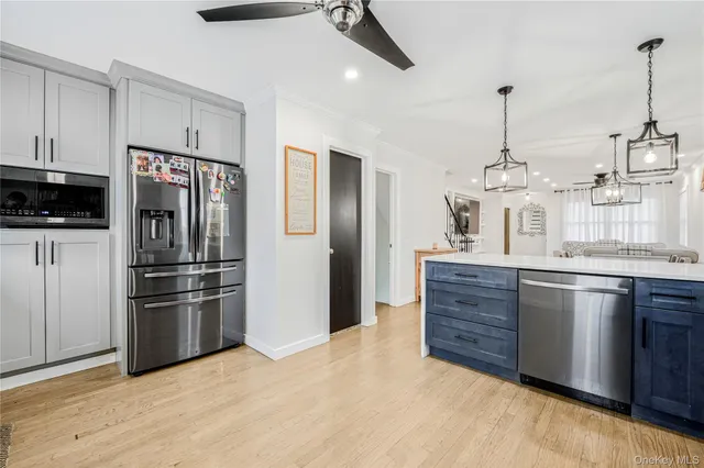 a kitchen with stainless steel appliances granite countertop a refrigerator and a sink