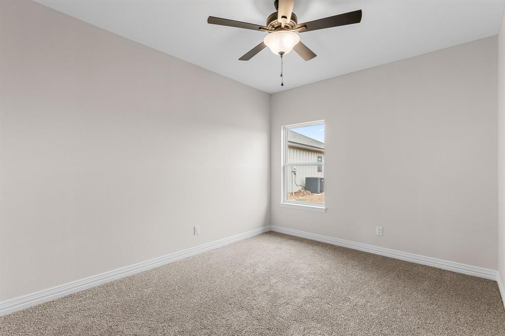 4695 Sisk Road Wichita Falls, TX 76310 - Photo 29 of 32 Carpeted spare room featuring ceiling fan