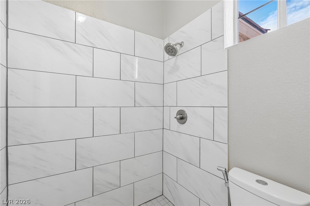 1727 Millstream Way Henderson, NV 89074 - Photo 37 of 46 A spacious, naturally illuminated shower with modern tilework awaits your daily refresh.