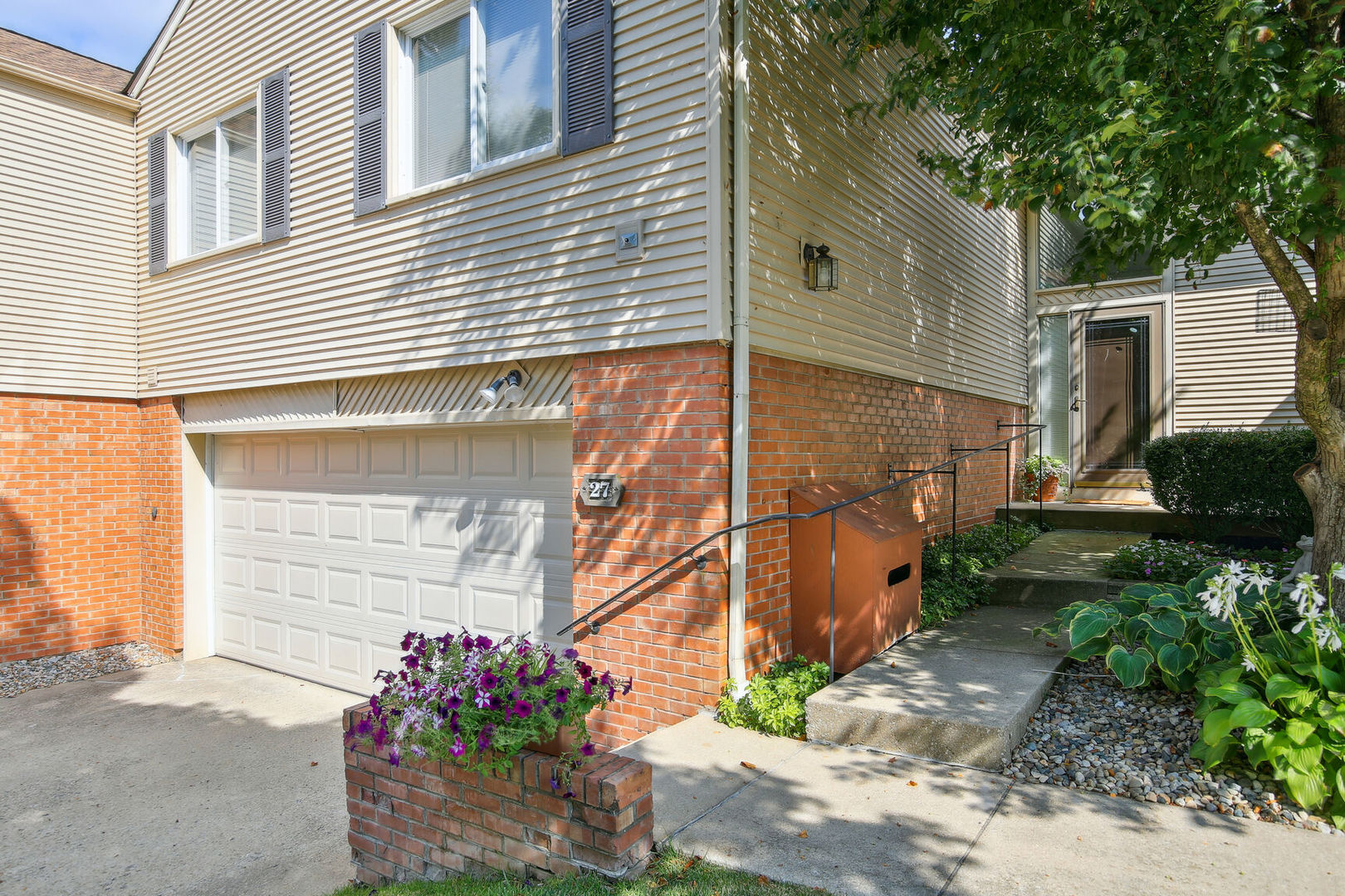 a backyard of a house with flower plants