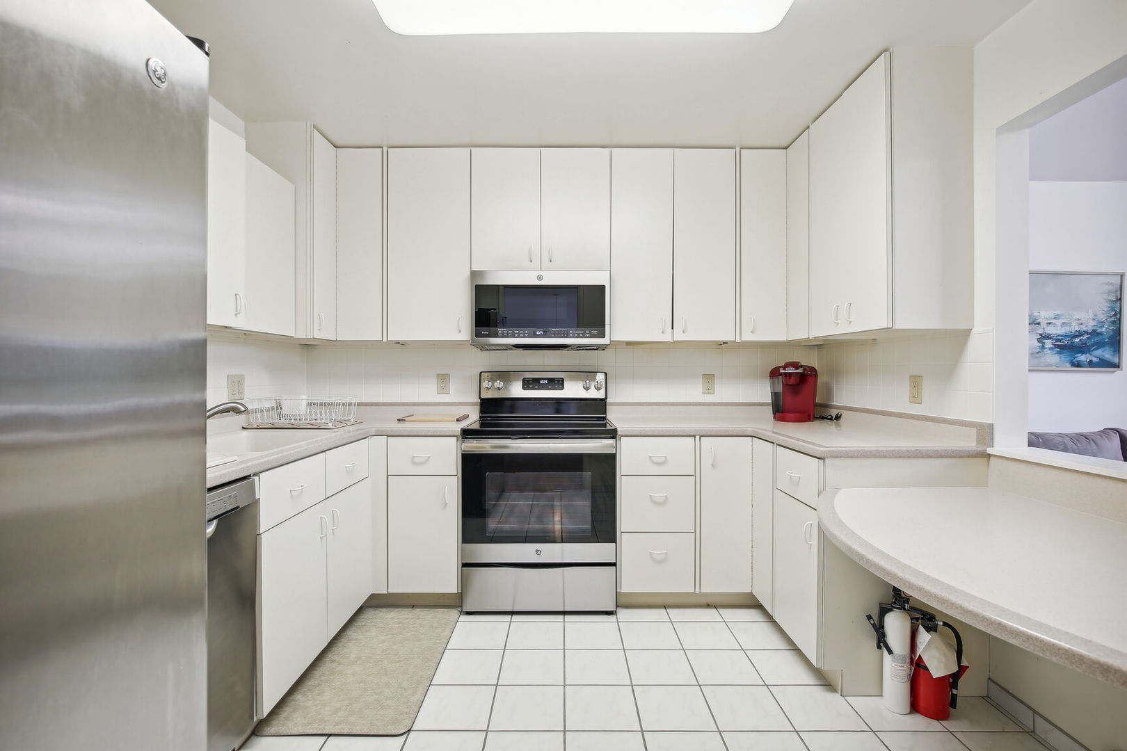 27 Fields East, Unit 27 Champaign, IL 61822 - Photo 13 of 35 a kitchen with a sink a stove and cabinets