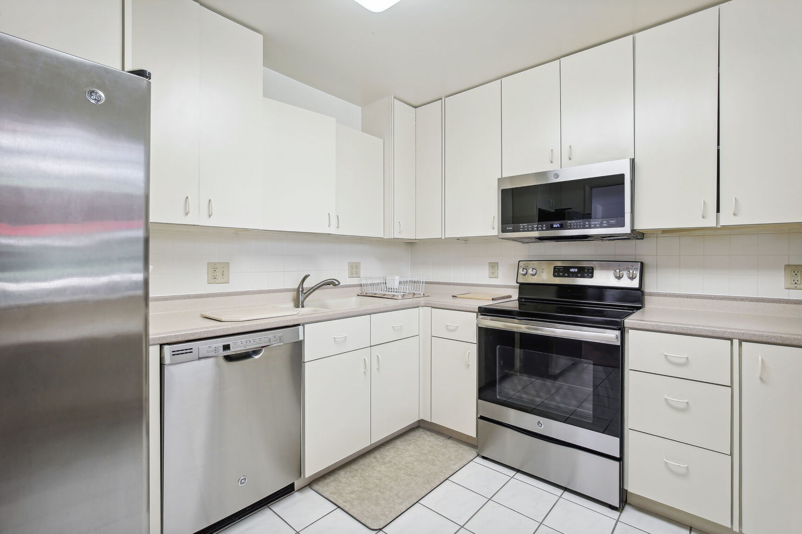 27 Fields East, Unit 27 Champaign, IL 61822 - Photo 14 of 35 a kitchen with cabinets stainless steel appliances and a sink