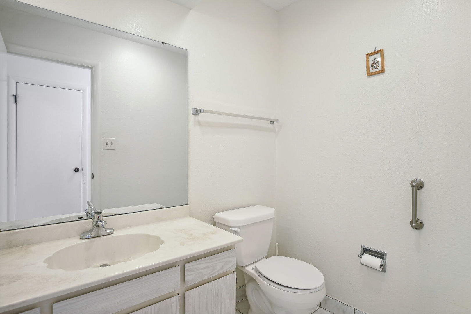 27 Fields East, Unit 27 Champaign, IL 61822 - Photo 16 of 35 a bathroom with a sink a toilet and a mirror