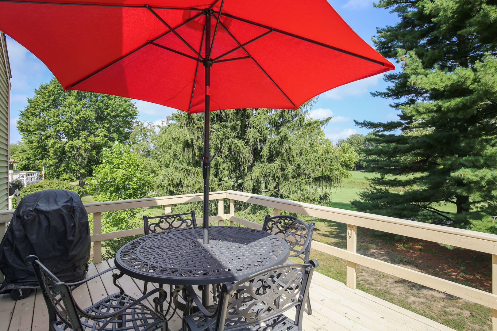 27 Fields East, Unit 27 Champaign, IL 61822 - Photo 31 of 35 a view of balcony with furniture and umbrella