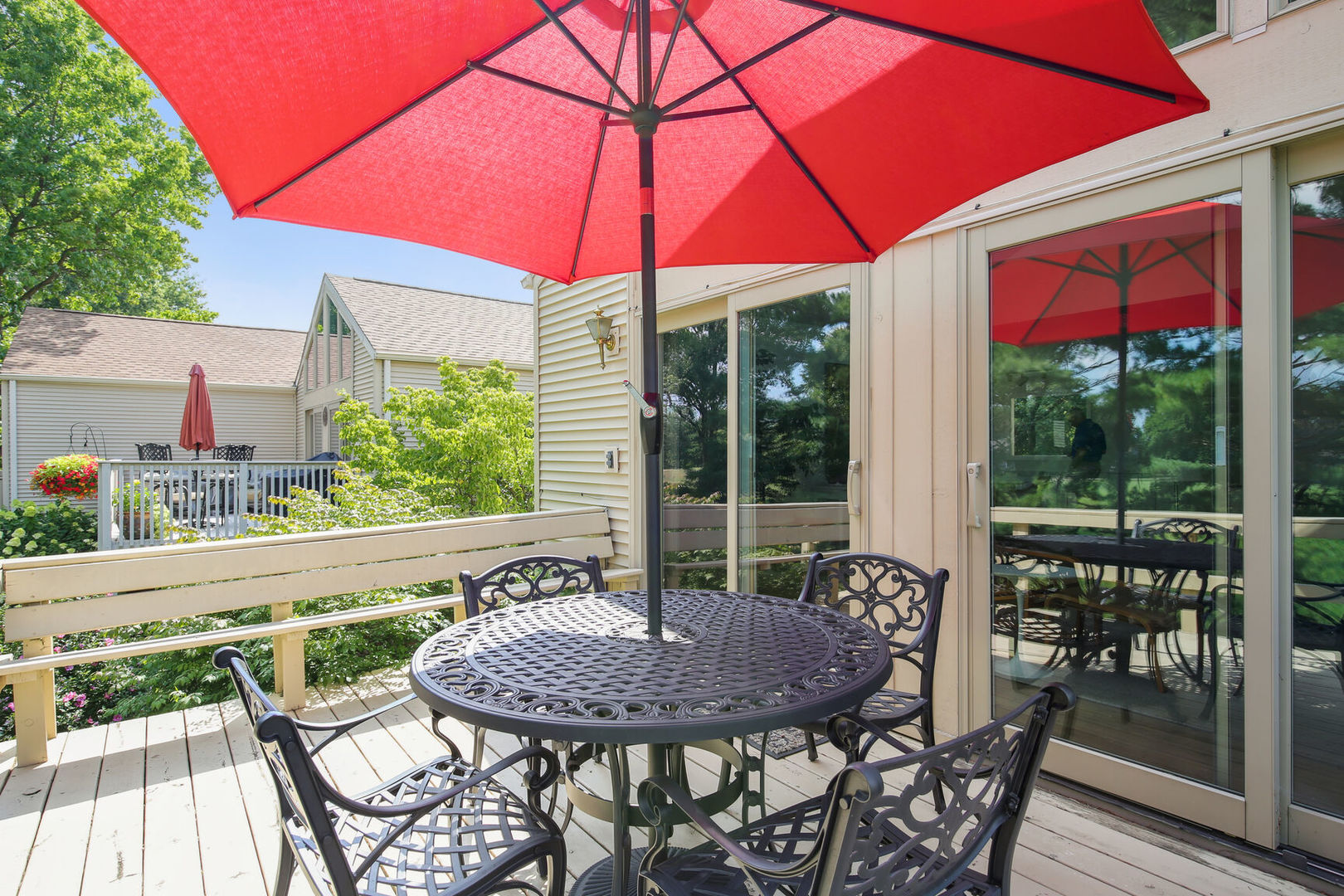 27 Fields East, Unit 27 Champaign, IL 61822 - Photo 32 of 35 a patio with a table and chairs under an umbrella