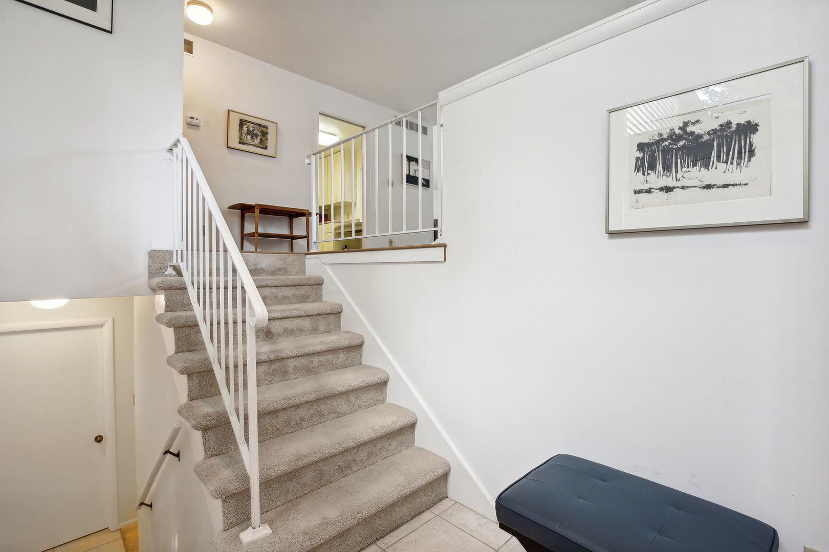 27 Fields East, Unit 27 Champaign, IL 61822 - Photo 5 of 35 a view of a hallway with staircase