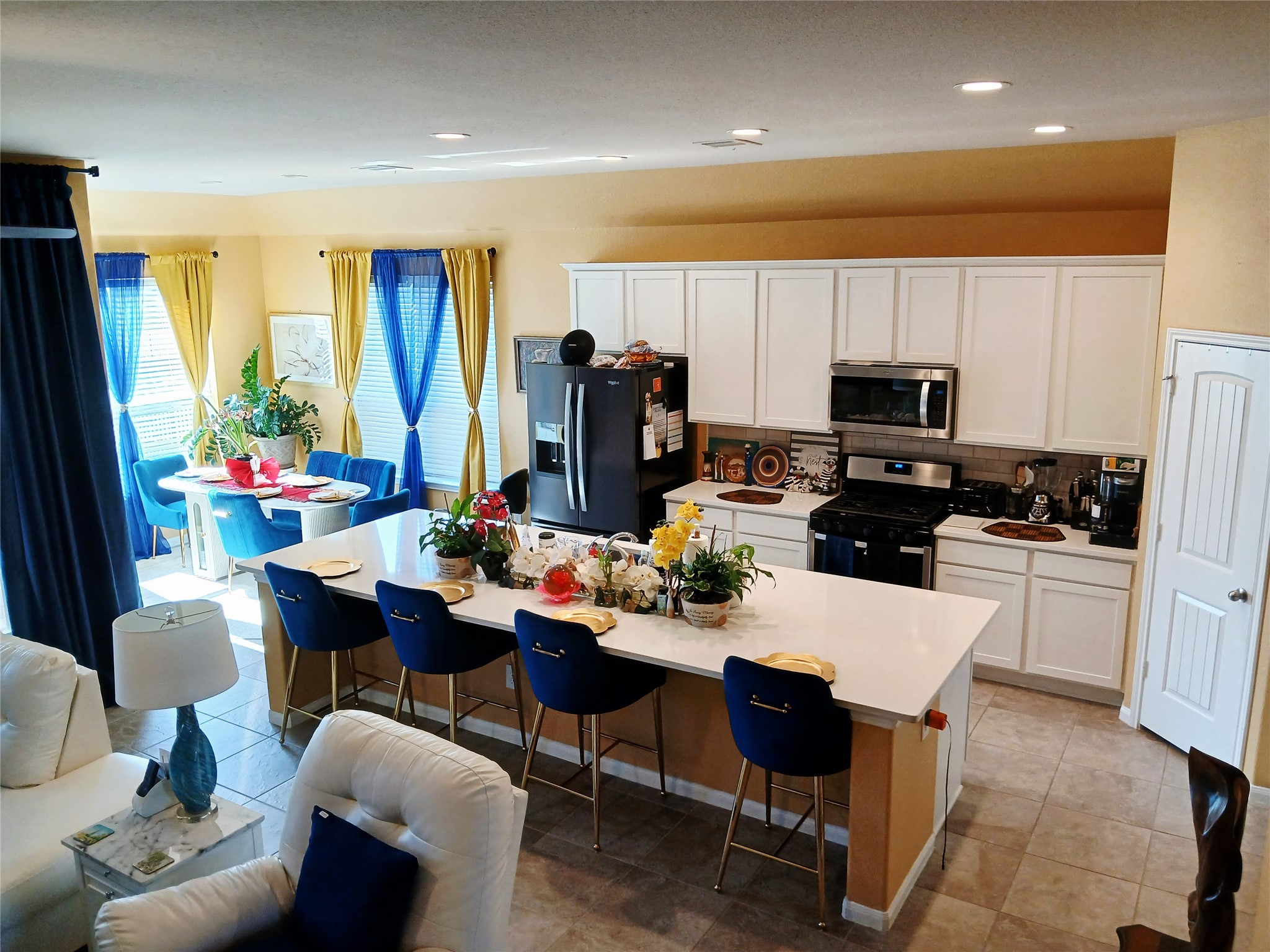 24015 Corinaldo Court Katy, TX 77493 - Photo 5 of 16 a kitchen with sink a refrigerator and chairs