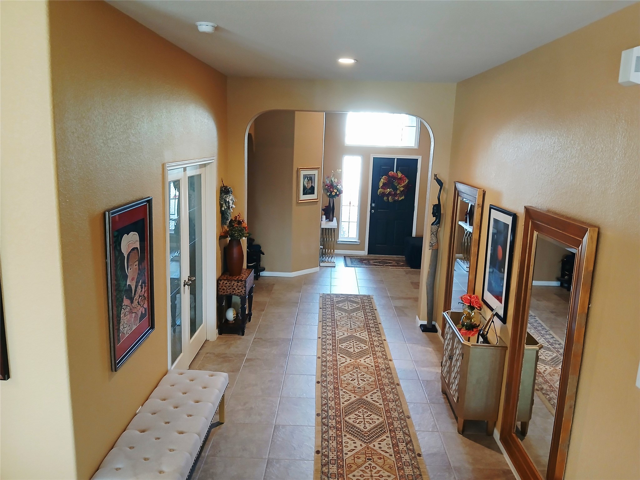 24015 Corinaldo Court Katy, TX 77493 - Photo 7 of 16 a view of a hallway with furniture and a window
