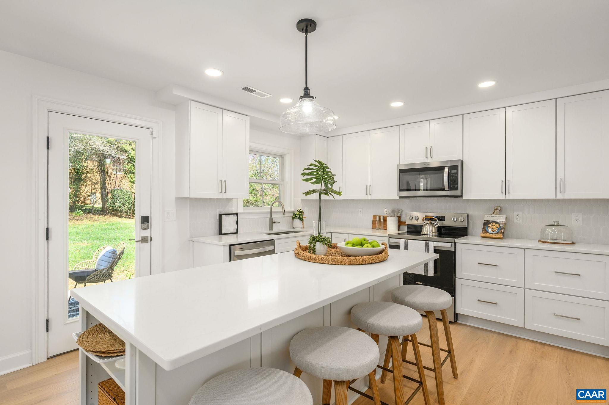 103 Chaucer Road Charlottesville, VA 22901 - Photo 13 of 34 a kitchen with white cabinets and stainless steel appliances
