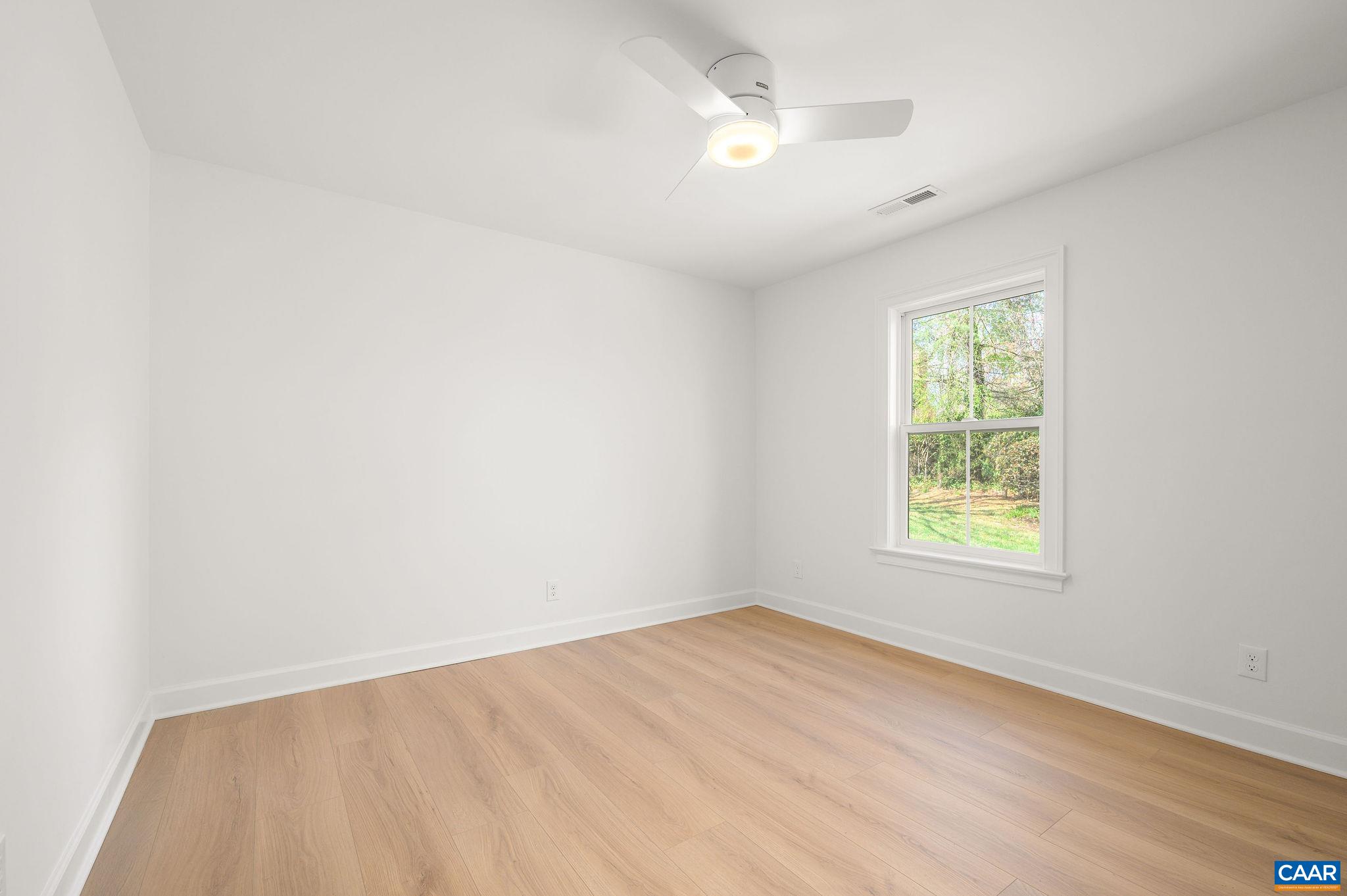 103 Chaucer Road Charlottesville, VA 22901 - Photo 23 of 34 an empty room with wooden floor and windows