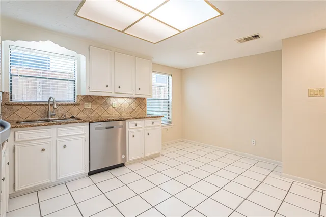 a kitchen with a sink and cabinets