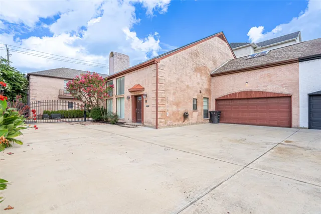 a front view of a building with a yard and garage