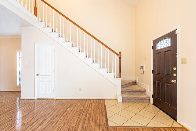 a view of staircase with wooden floor and a large window