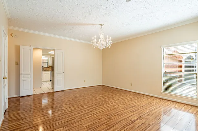a view of wooden floor and windows in a room