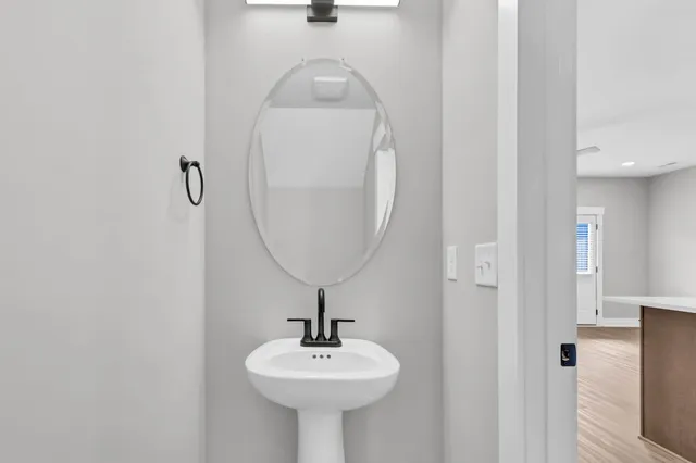 a bathroom with a sink a mirror and shower