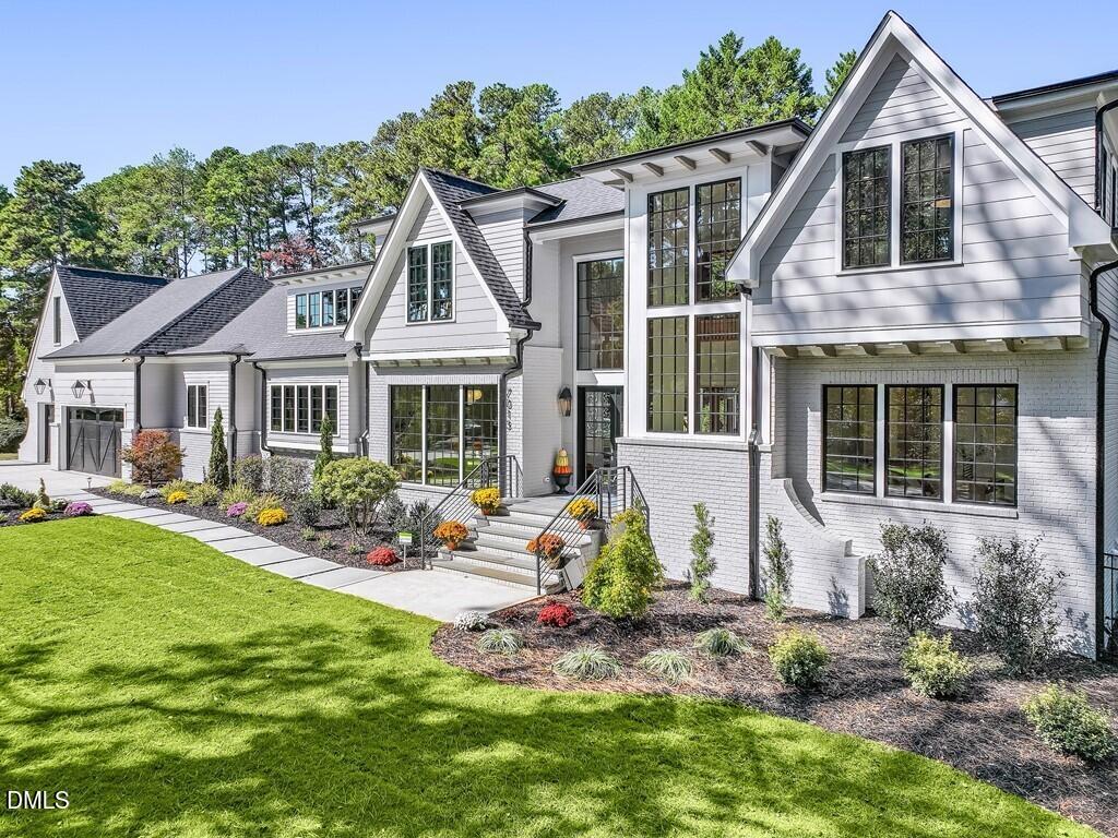 7013 Buckhead Drive Raleigh, NC 27615 - Photo 2 of 80 a front view of a house with garden