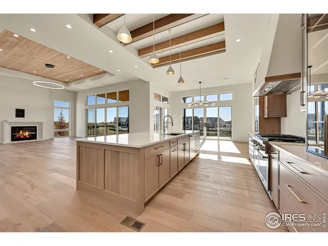 a large white kitchen with lots of counter space and window