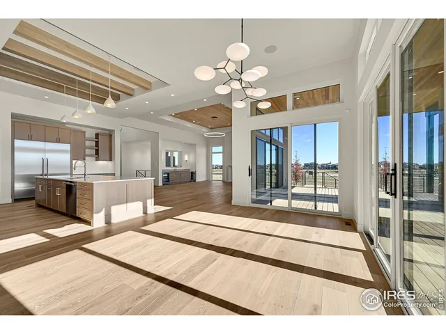 a view interior of kitchen and hall with wooden floor