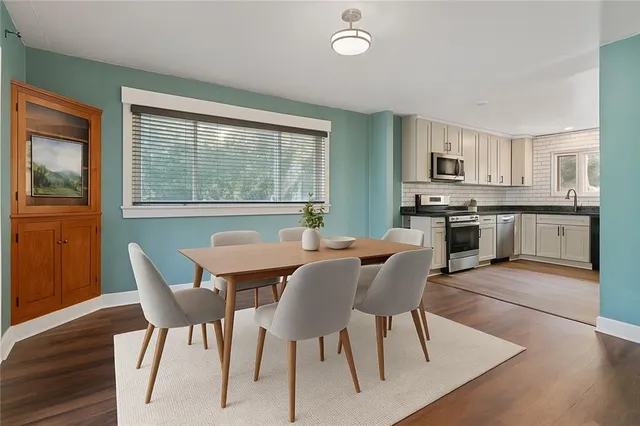 a dining room with furniture and window