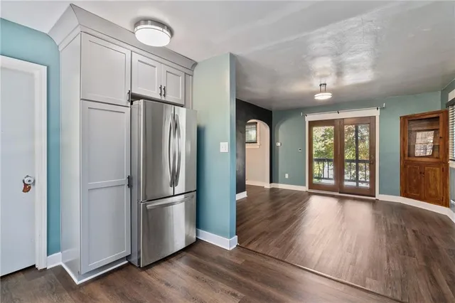 a kitchen with stainless steel appliances granite countertop a refrigerator and a refrigerator