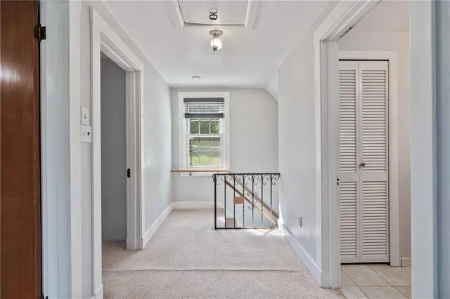 a view of a hallway with windows and stairs