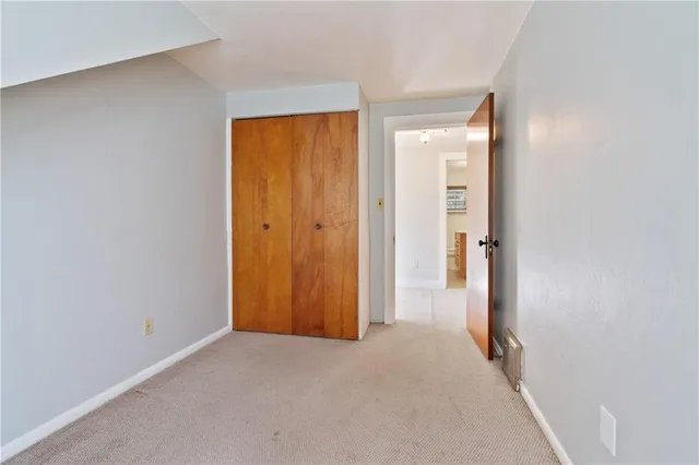 a view of a hallway with wooden shelves