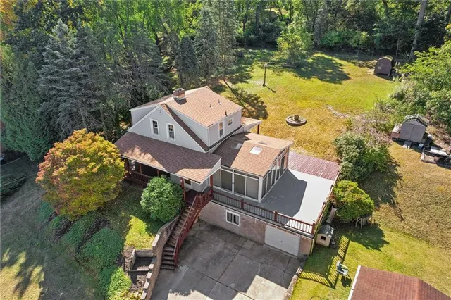 an aerial view of a house with swimming pool and outdoor space