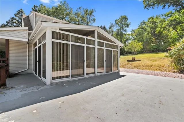 a view of a house with a yard and potted plants