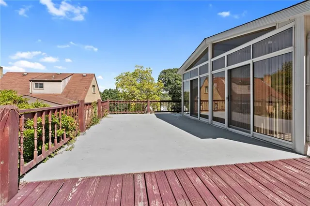 a view of balcony with wooden floor and fence