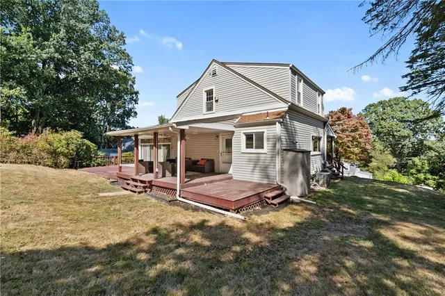 a view of a house with backyard and sitting area