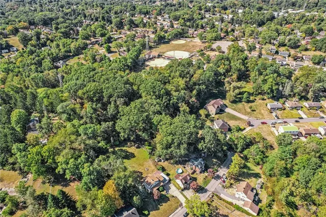 an aerial view of residential house with yard and outdoor space