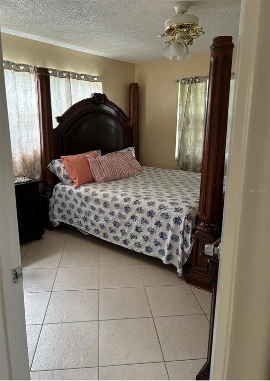 240 Northampton L, Unit 240 West Palm Beach, FL 33417 - Photo 2 of 11 a bedroom with a large bed and a mirror