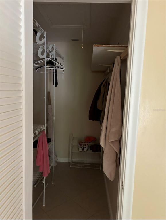 240 Northampton L, Unit 240 West Palm Beach, FL 33417 - Photo 4 of 11 a view of walk in closet with clothes and shoes