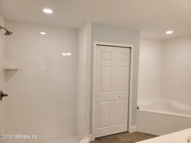 a white bath tub sitting in a bathroom