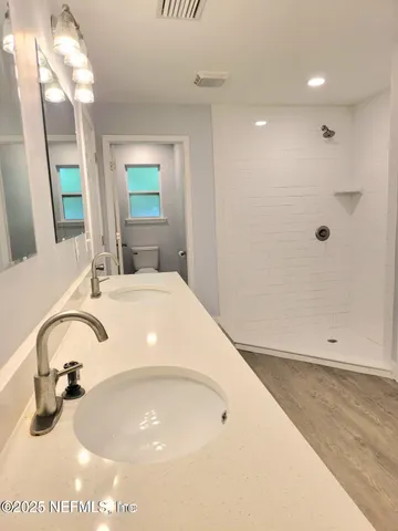 a bathroom with a toilet and a mirror