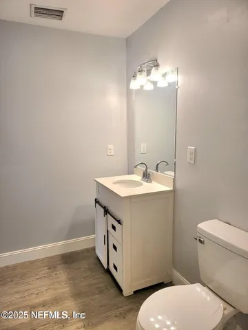 a bathroom with a sink a toilet and vanity
