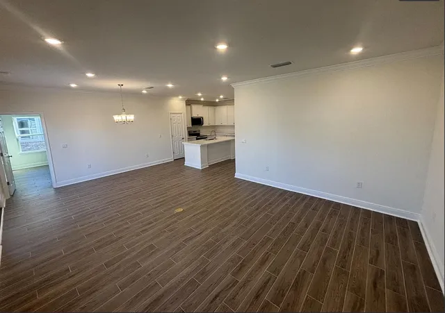 a kitchen with a refrigerator a sink and cabinets
